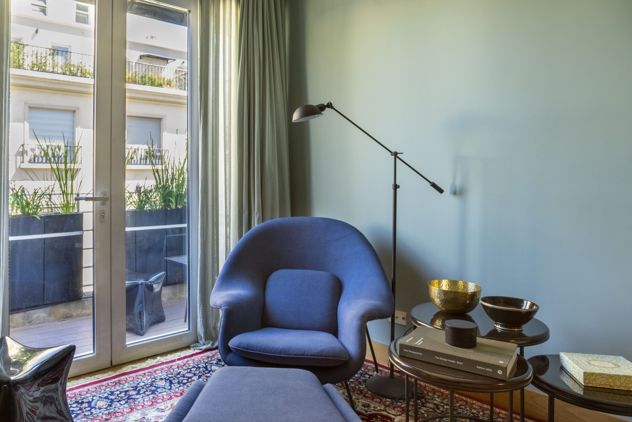 Armchair by the balcony doors in the living room, Alvear Design Guest House