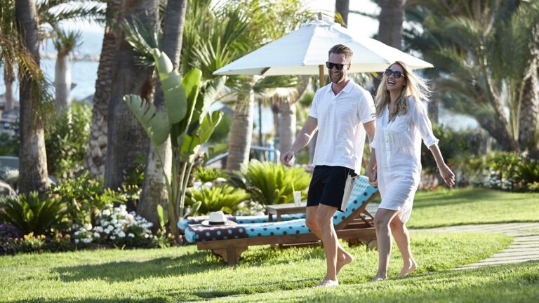 Guests walking through the hotel gardens, Amathus Beach Hotel