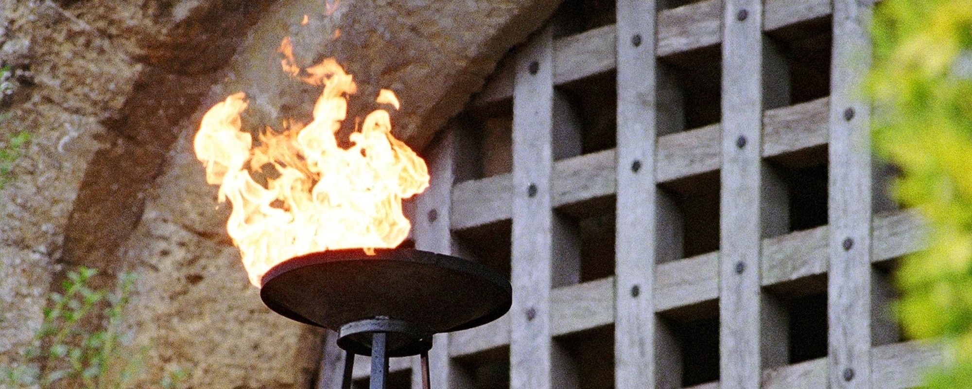A flaming torch burning beside the castle's wooden portcullis, Amberley Castle