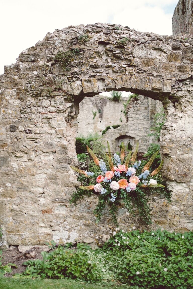 A floral arrangement set into a ruined stone wall of the castle, Amberley Castle