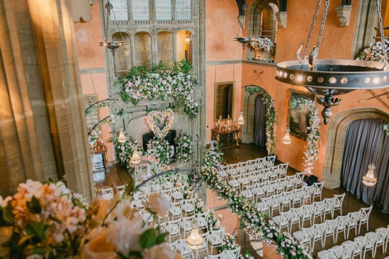 A ceremony beneath a floral heart, Cowdray House, Amie Bone