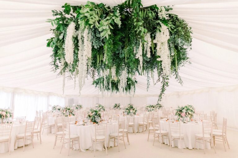 A hanging installation of white wisteria and greenery, a marquee reception, Amie Bone