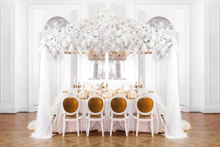 An all-white reception beneath a floral canopy, Amie Bone