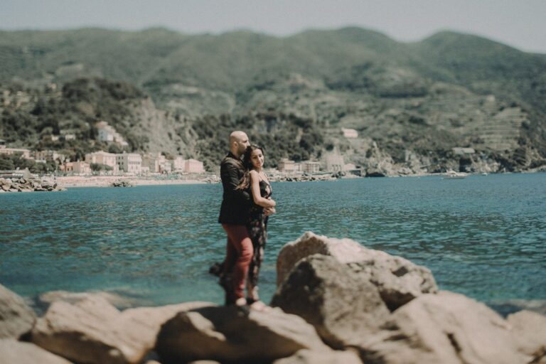 An embrace with the village behind them — Mandeep and Rita, Monterosso al Mare, Andrea & Federica