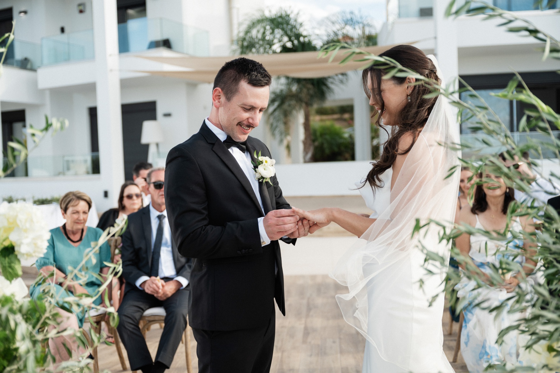 The ring exchange, the villa behind them, Andreas Markakis Photography