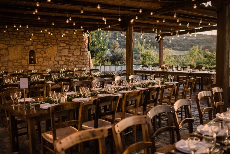 The farmhouse table, strung with lights, the hills behind, Andreas Markakis Photography