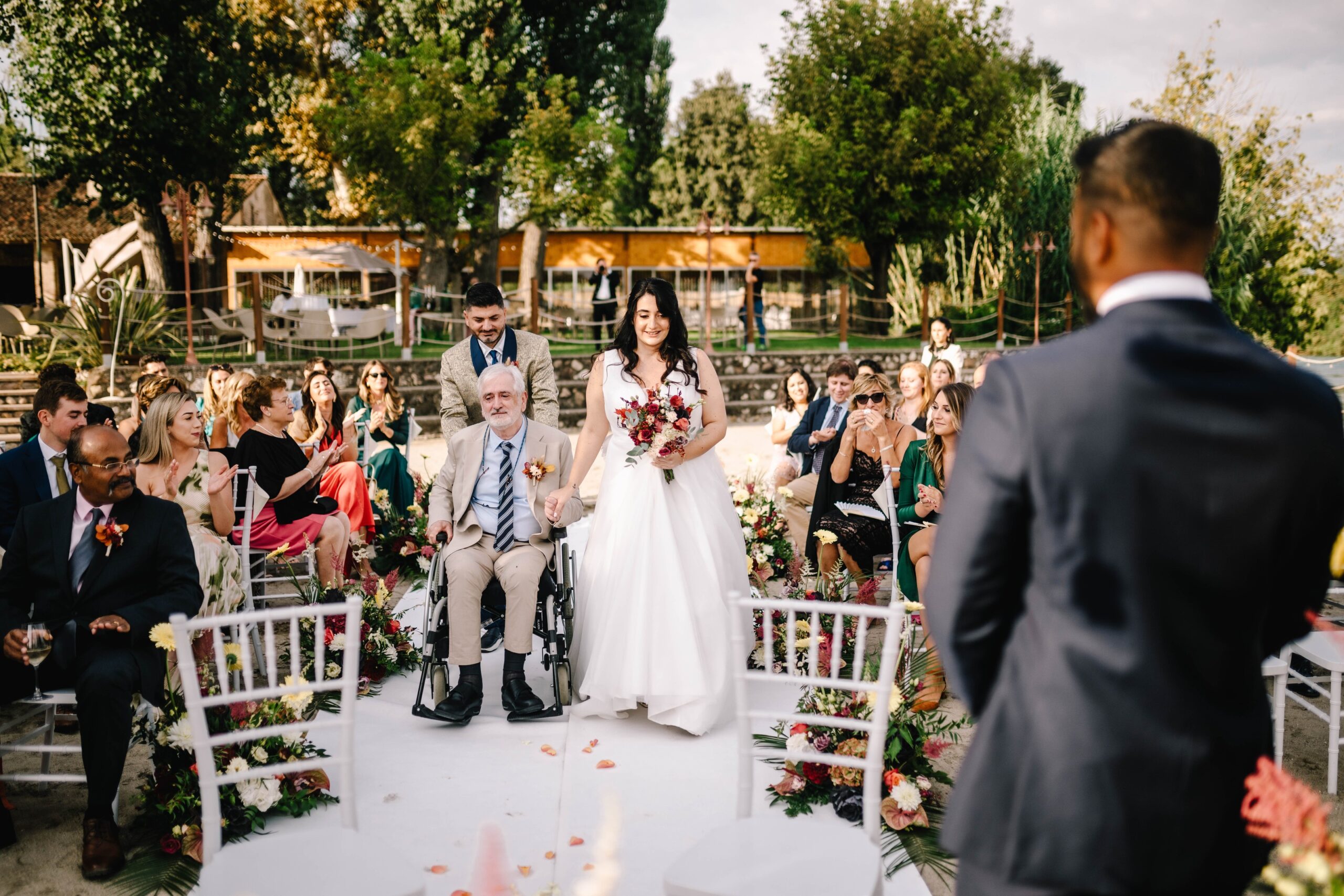 The bride walking down the aisle between guests, Lake Garda, Angela Salzano