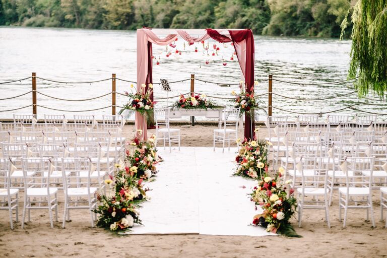 Ceremony chairs, aisle and floral arch beside the water, Angela Salzano