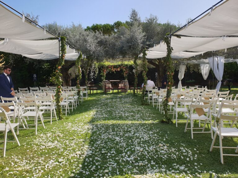 Ceremony on a lawn with petals along the aisle, Angela Salzano