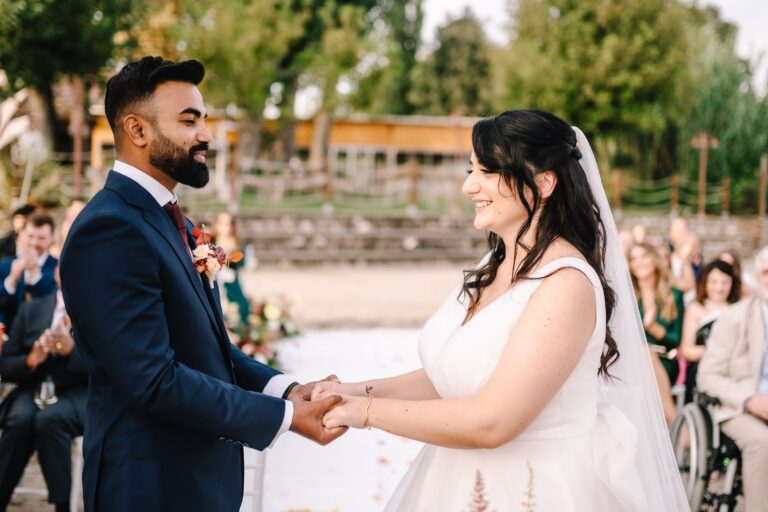 The couple exchanging vows, hand in hand, Angela Salzano