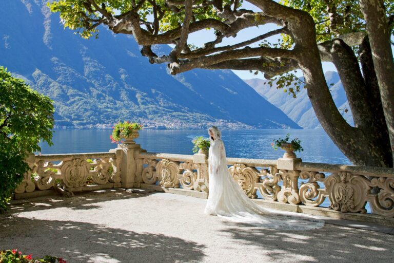 A bride on a lakeside terrace beneath an old tree, Lake Como, Angela Salzano