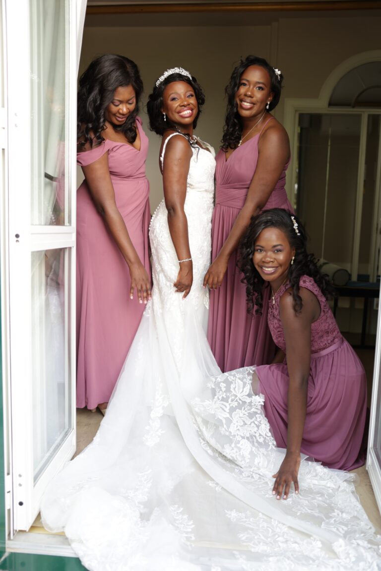The bride with her bridesmaids at an open doorway, Angela Salzano