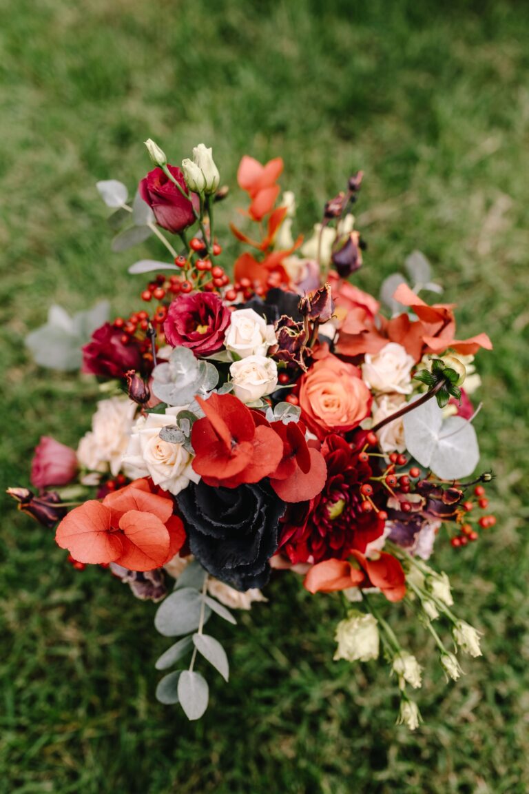 A red and coral bridal bouquet on the lawn, Angela Salzano