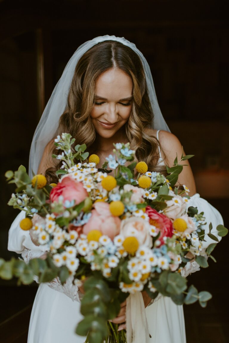 A bride with a bouquet of yellow and pink flowers, Angela Salzano
