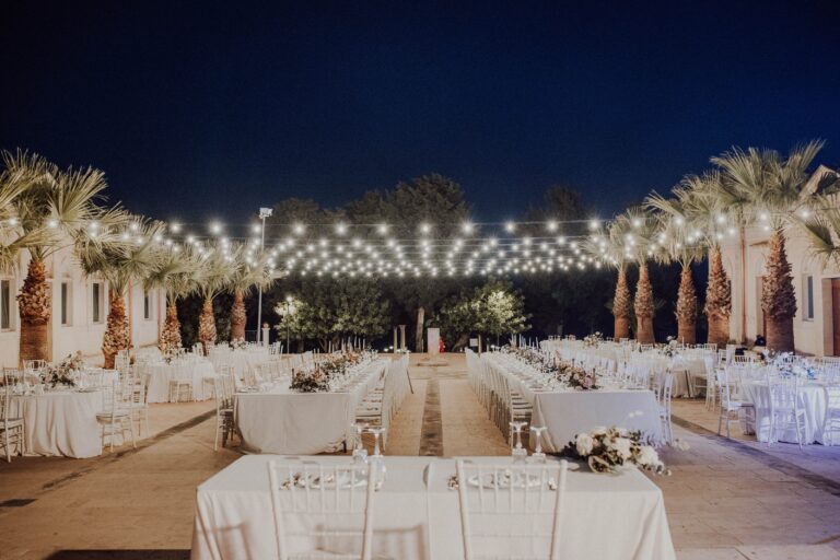 Reception tables under string lights at night, Angela Salzano
