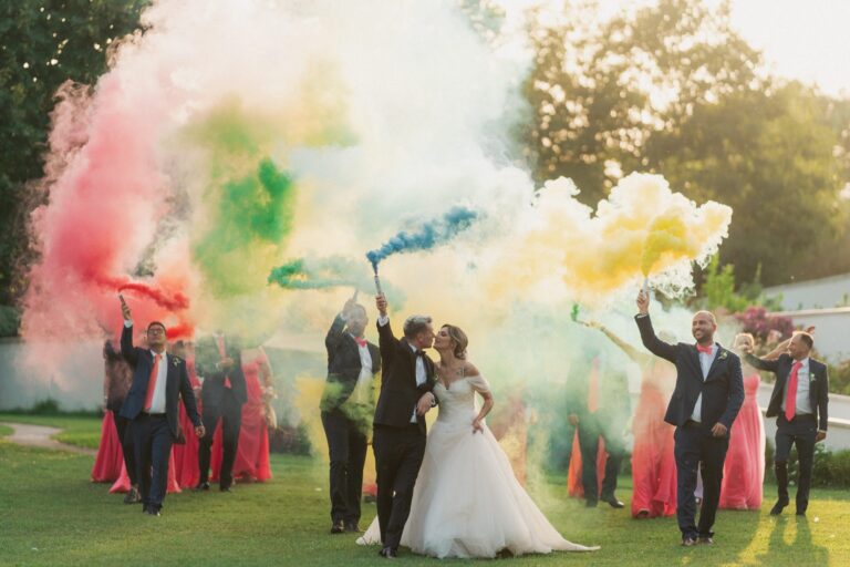 Coloured smoke held up by the wedding party, the couple standing in the middle of it, Anita Galafate