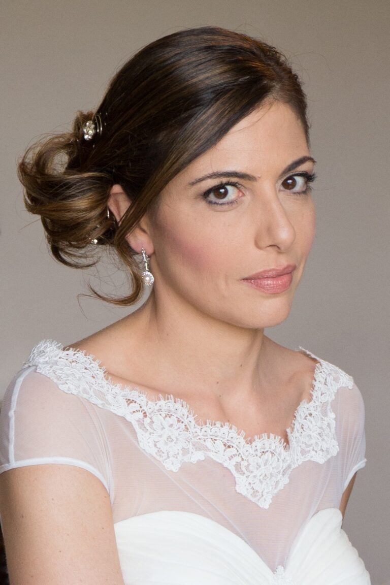 A bride in lace, her hair swept into a low chignon, Anna Rosa Makeup Italy
