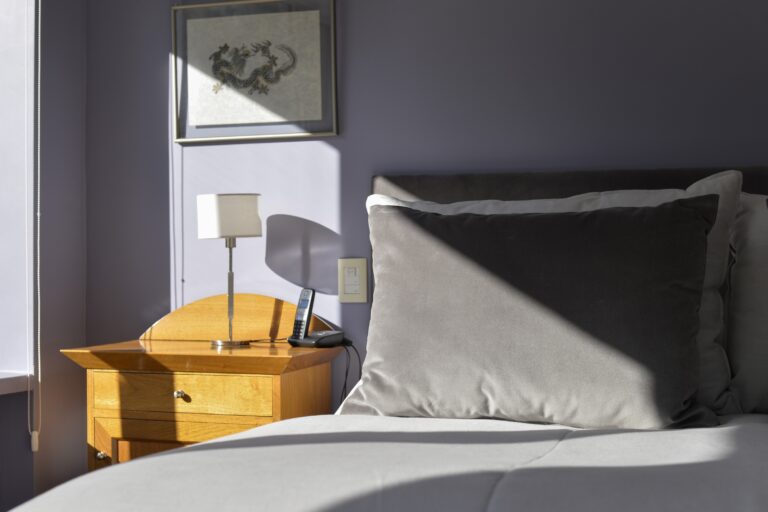 Bedside table and pillows in a guest room, Antucura Wine Estate