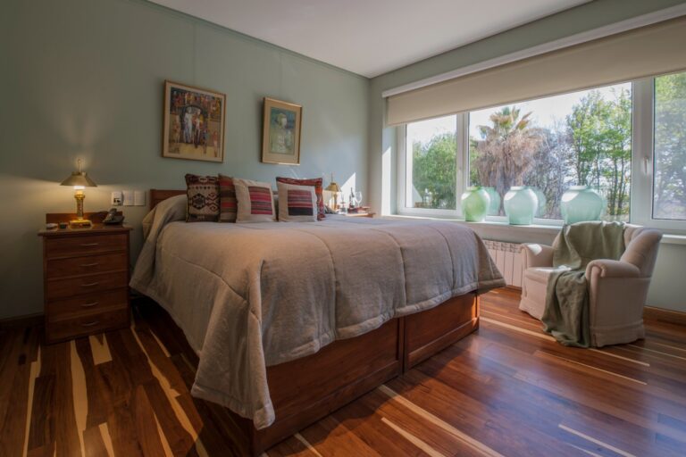 Bedroom with pale green walls and a wide window, Antucura Wine Estate