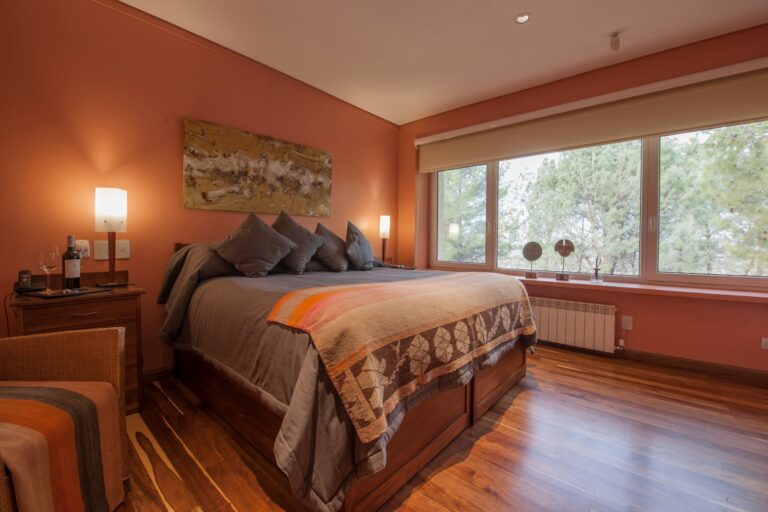 Room with a patterned bedspread and warm walls, Antucura Wine Estate