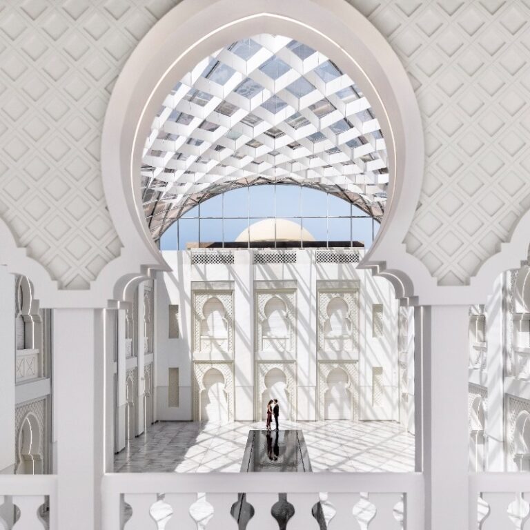 A carved white arch looking up to the Skylight glass roof, Arjaan by Rotana Dubai Media City