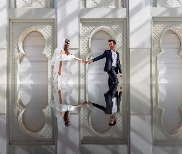 A couple between the arched white panels of Skylight, Arjaan by Rotana Dubai Media City