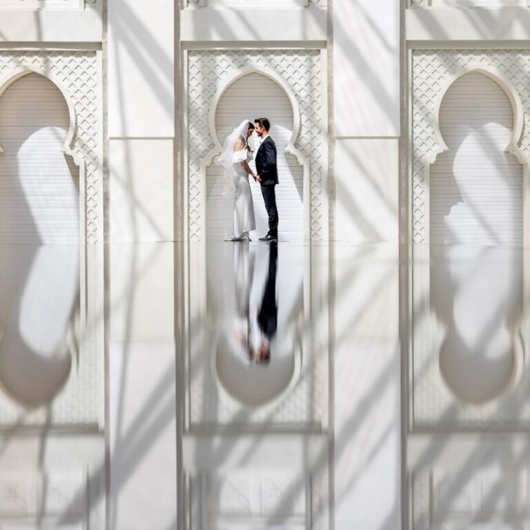 A couple framed in a white archway at Skylight, Arjaan by Rotana Dubai Media City