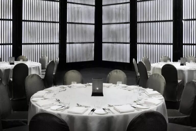Round tables set for a banquet in the Armani/Ballroom, Armani Hotel Dubai