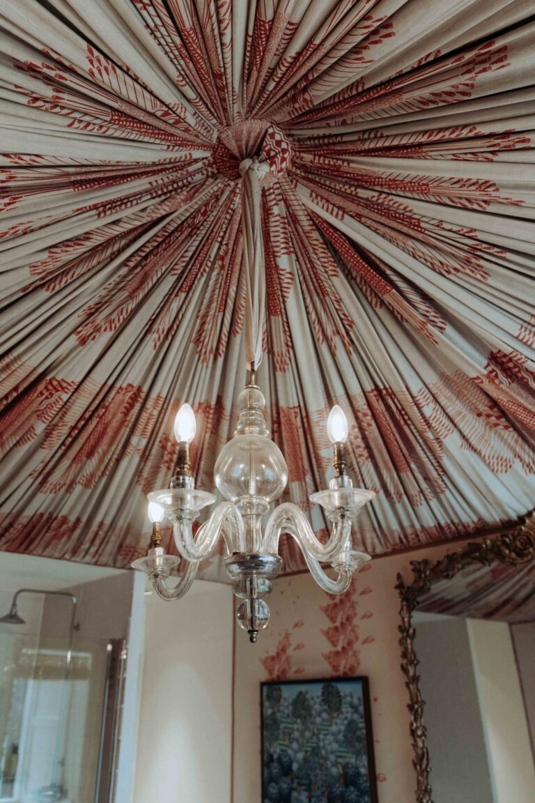 The tented fabric ceiling and glass chandelier in Lonsdale, the suggested room for the couple, Askham Hall