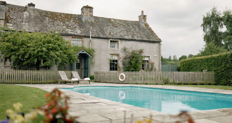The heated outdoor pool in a walled corner of the garden, open to residents in summer, Askham Hall