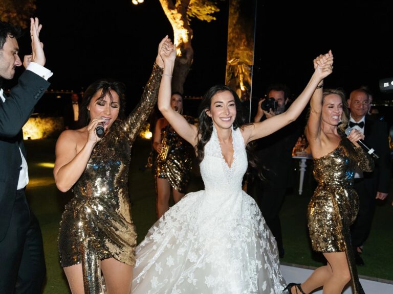 A bride dancing with the singers on the stage at night, Aston Band