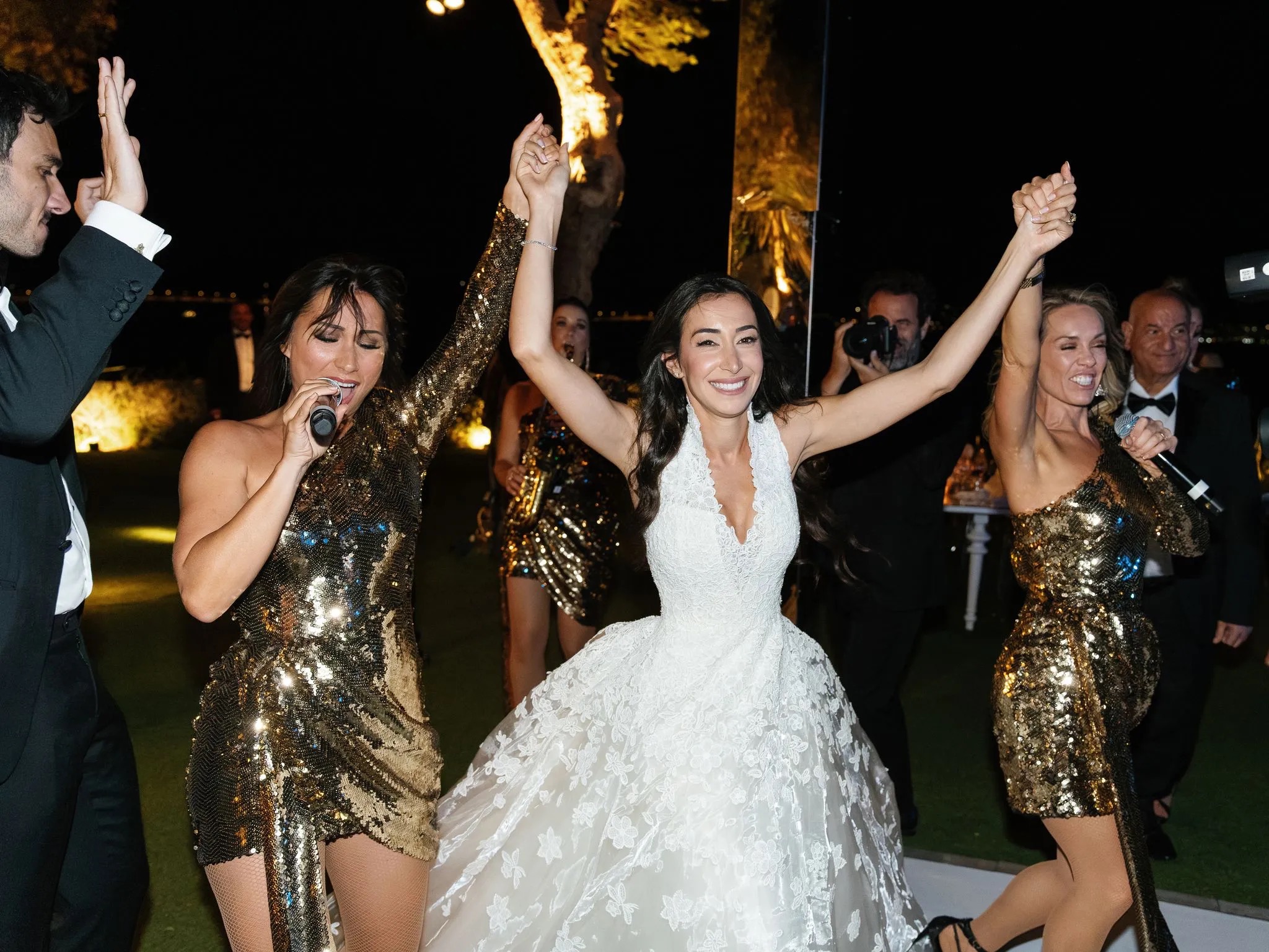 A bride dancing with the singers on the stage at night, Aston Band
