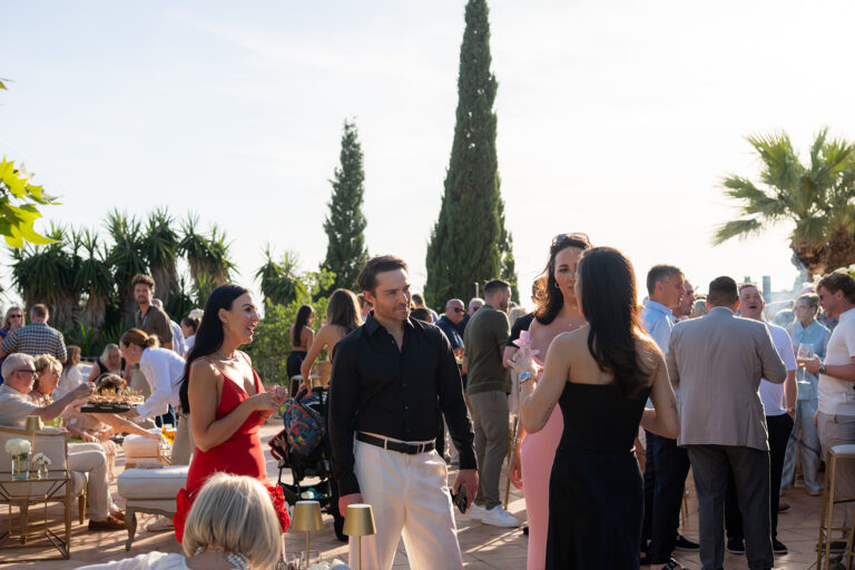Guests gathering at a terrace welcome drinks reception, Aston Band
