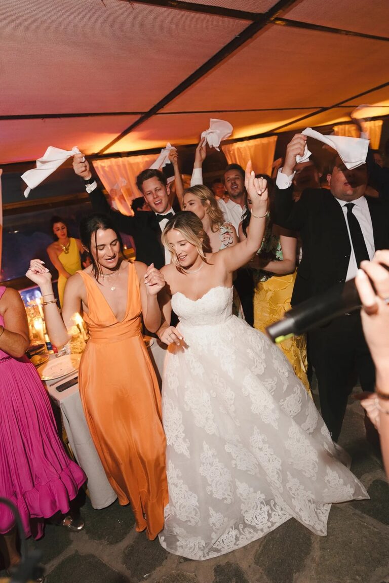 A bride dancing among her guests during the wedding dinner, Aston Band
