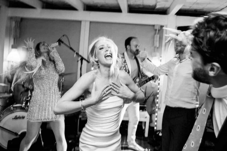 A bride dancing alongside the singers in black and white, Aston Band