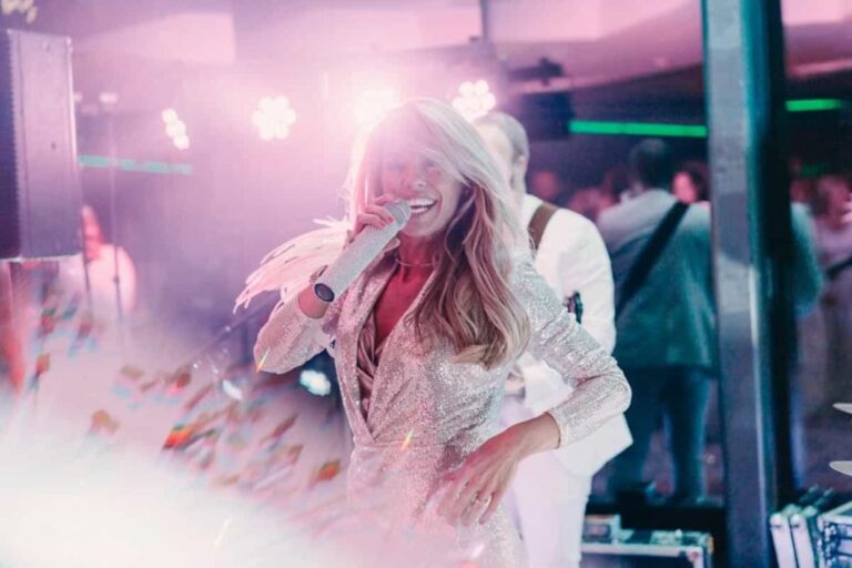 A bride dancing with the band behind her, in black and white, Aston Band