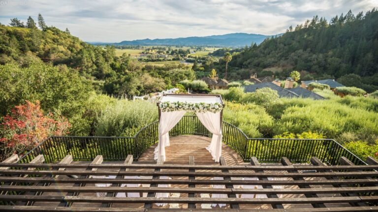 A circular floral arch ceremony aisle above the valley, Auberge du Soleil
