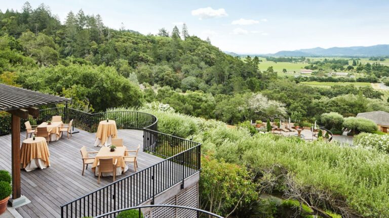 An evening reception beneath the pergola, valley views beyond, Auberge du Soleil