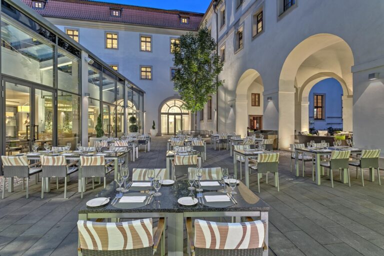 Glass-roofed terrace restaurant in the courtyard, Augustine Hotel, Prague