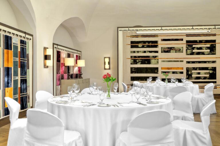 Round tables dressed for a banquet, Augustine Hotel, Prague