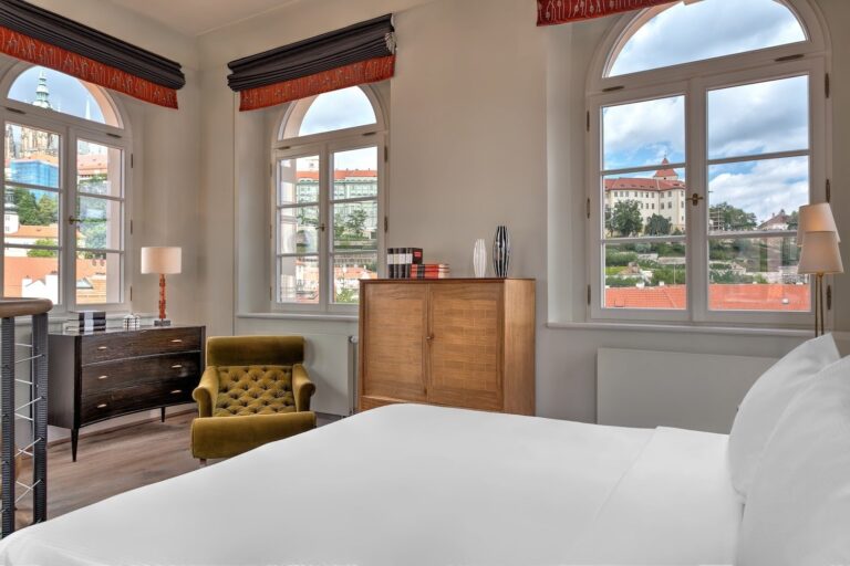 Bedroom with arched windows and castle views, Augustine Hotel, Prague
