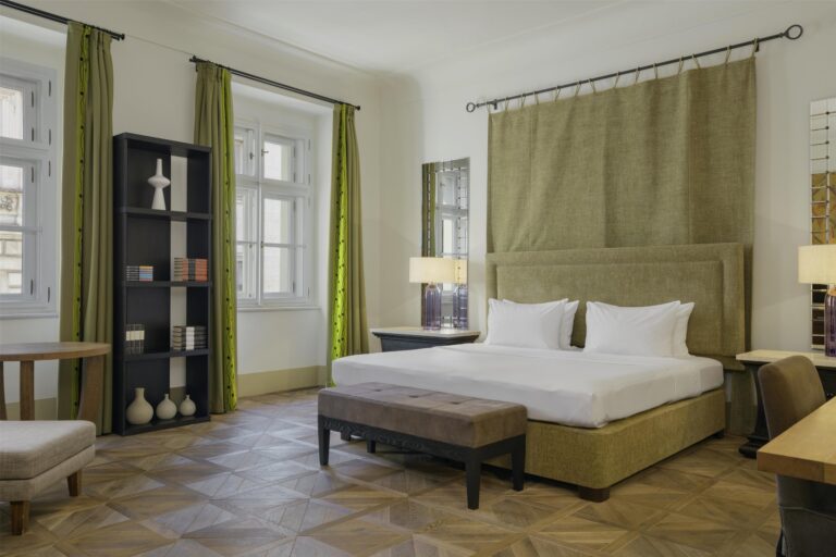 Room with vaulted windows and a king bed, Augustine Hotel, Prague