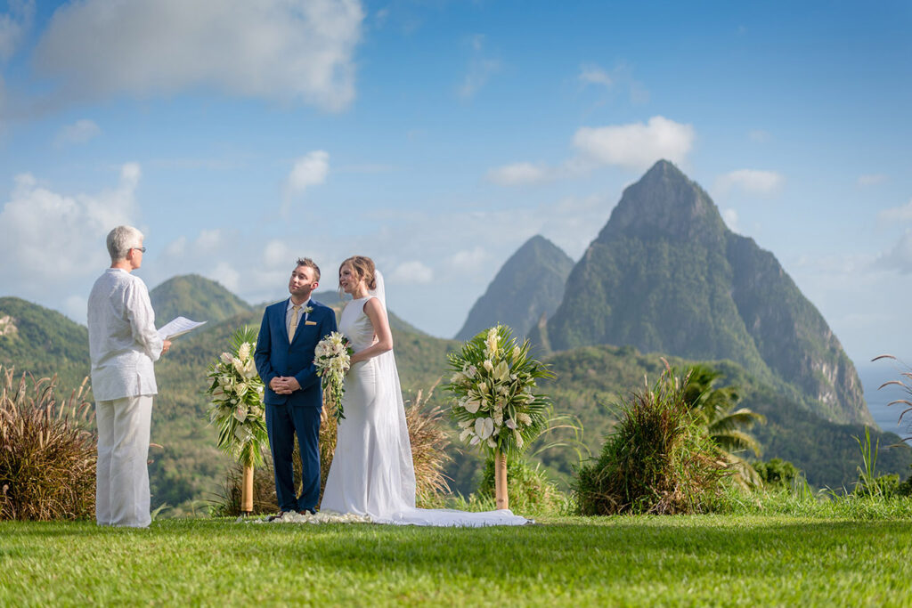 A ceremony on a lawn facing the Pitons
