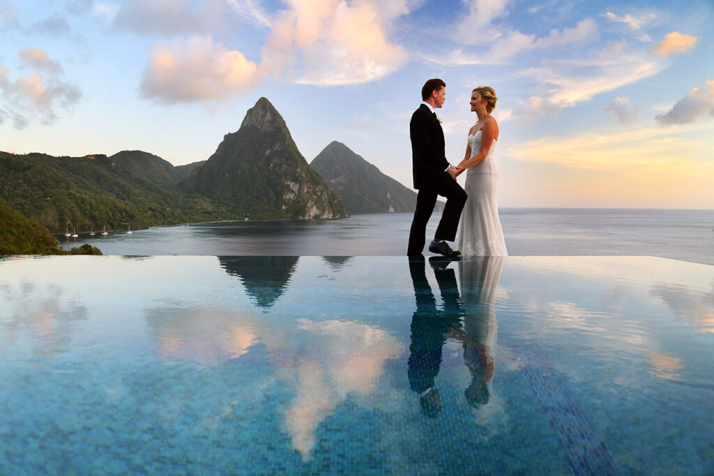 A couple with their guests on the deck of a catamaran