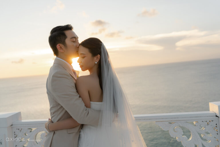 Couple embracing in golden light on a seaside terrace, Bali, Axioo Bali