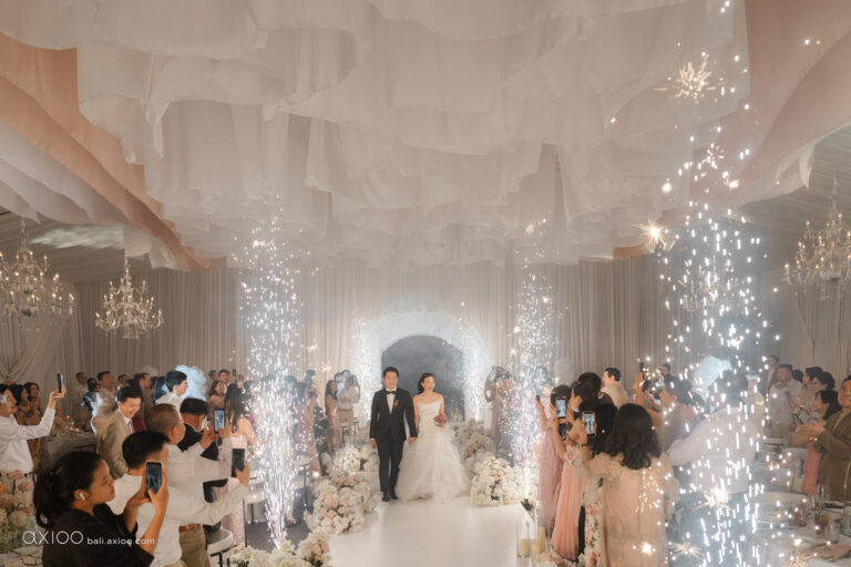Draped reception hall with cold sparklers as the couple arrive, Bali, Axioo Bali