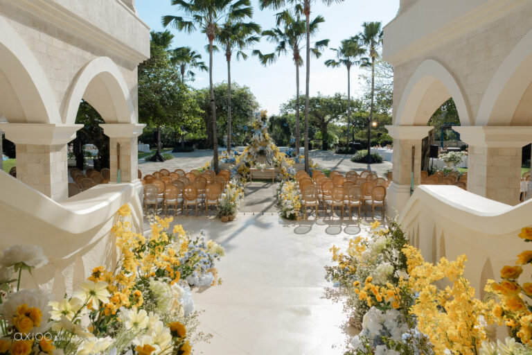 Arched colonnade and aisle lined with yellow and blue florals, Jumeirah Bali, Axioo Bali