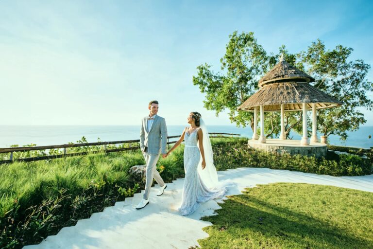 Couple walking the path to the gazebo above the sea at SKY, Ayana Estate Bali