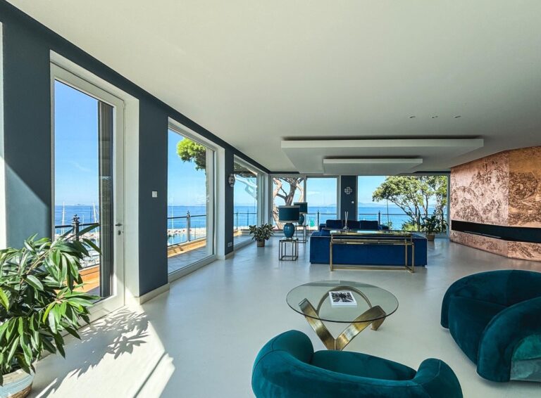 The living room of a two-bedroom suite, glass opening to the sea, Baglioni Resort Cala del Porto