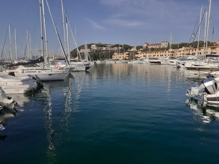 The yachts of Punta Ala marina on still water below the resort, Baglioni Resort Cala del Porto